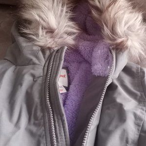 Brand new gray, faux-fur hooded coat.